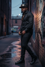 Load image into Gallery viewer, A black snapback cap with a metal patch that reads 'KING' on the front, featuring a textured design and a flat visor.